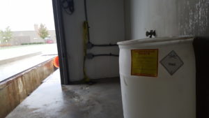 White plastic hazardous waste container