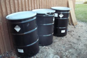 Three containers of hazardous waste accumulated at a VSQG