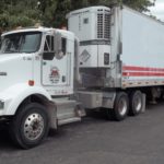 Semi-tractor trailer combination displaying Class 9 placard