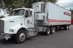 Semi-tractor trailer combination displaying Class 9 placard