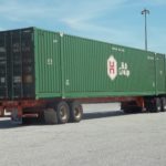 Freight container loaded on trailer of semi tractor trailer