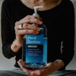 Person with Hand Sanitizer Pump