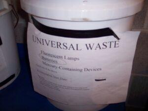 Container of universal waste batteries